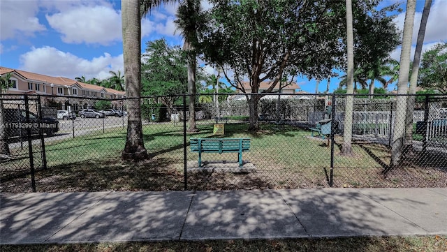 surrounding community featuring fence and a yard
