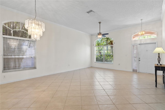 unfurnished dining area with visible vents, a textured ceiling, ceiling fan with notable chandelier, and light tile patterned flooring