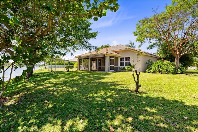 view of yard featuring fence and a sunroom