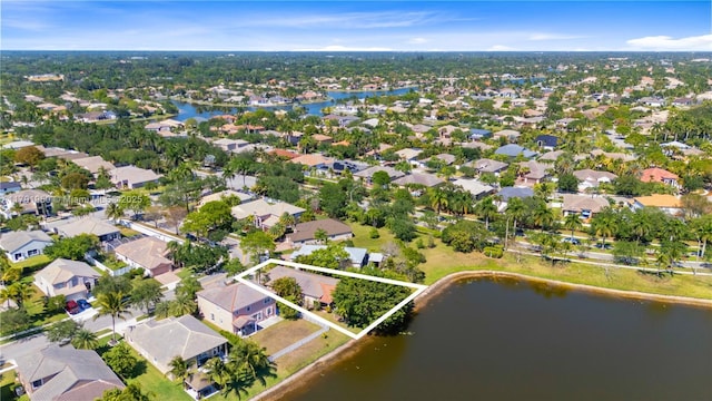 drone / aerial view with a water view and a residential view