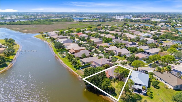 birds eye view of property with a water view and a residential view