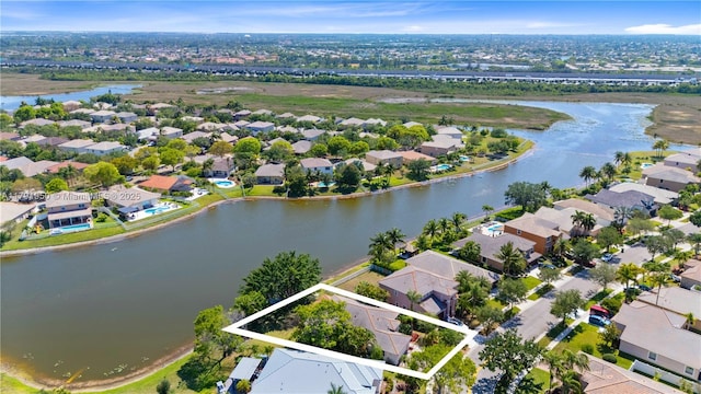 bird's eye view featuring a residential view and a water view