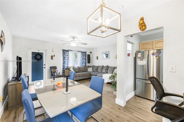 dining space with light wood-type flooring, baseboards, and ceiling fan