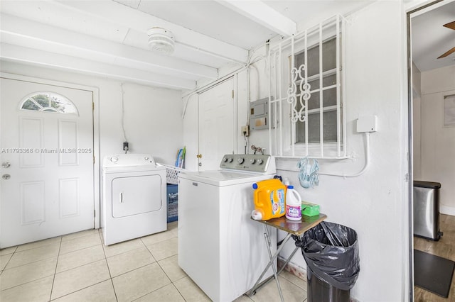 laundry area with laundry area, light tile patterned floors, and washing machine and clothes dryer