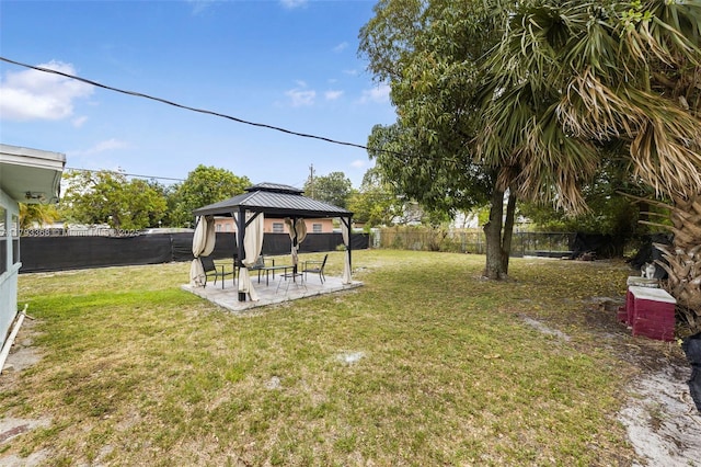 view of yard featuring a gazebo, a fenced backyard, and a patio area