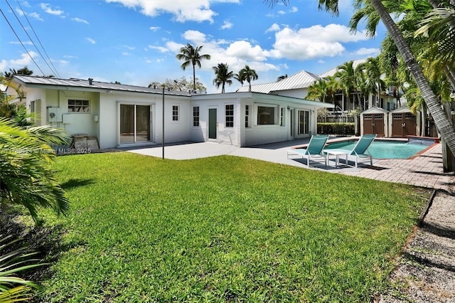 255 Ridgewood Rd, Key Biscayne, FL 33149 - back of house featuring a patio area, a shed, stucco siding, an outdoor structure, and metal roof