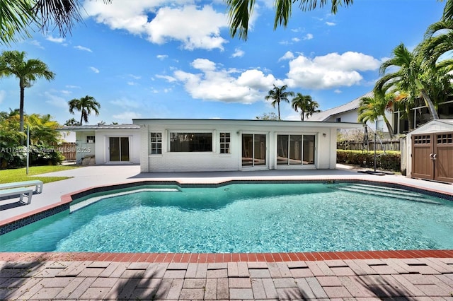255 Ridgewood Rd, Key Biscayne, FL 33149 - view of swimming pool with a shed, a patio, fence, and an outdoor structure