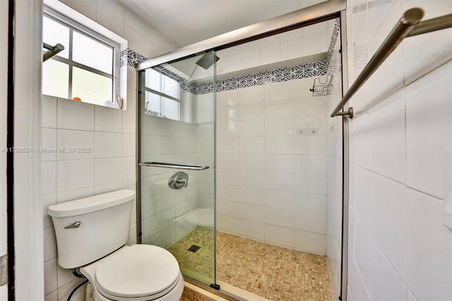 255 Ridgewood Rd, Key Biscayne, FL 33149 - full bath with a stall shower, toilet, and tile walls