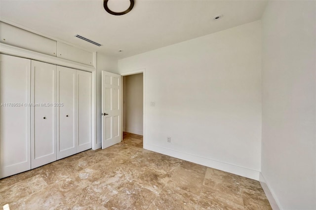 255 Ridgewood Rd, Key Biscayne, FL 33149 - unfurnished bedroom featuring baseboards and a closet
