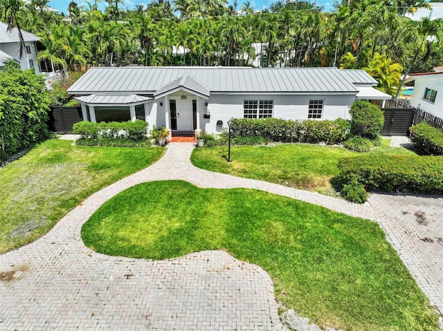 255 Ridgewood Rd, Key Biscayne, FL 33149 - single story home featuring stucco siding, metal roof, and a standing seam roof