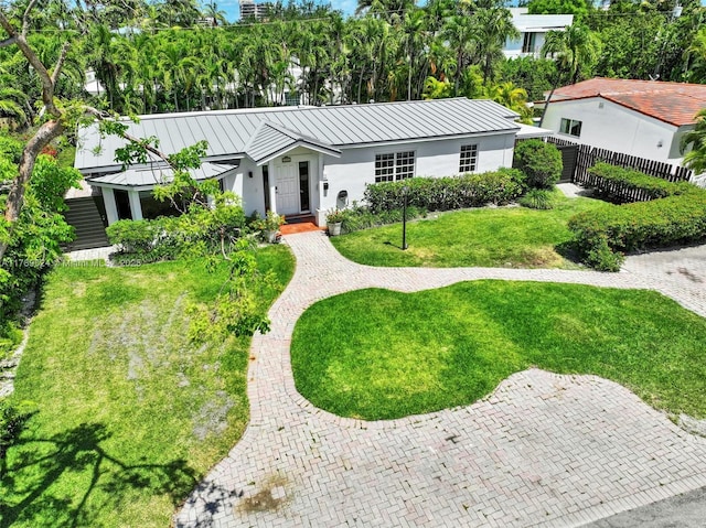 255 Ridgewood Rd, Key Biscayne, FL 33149 - view of front facade with stucco siding, a standing seam roof, and metal roof