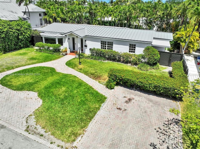 255 Ridgewood Rd, Key Biscayne, FL 33149 - view of front of house with stucco siding, a standing seam roof, and metal roof