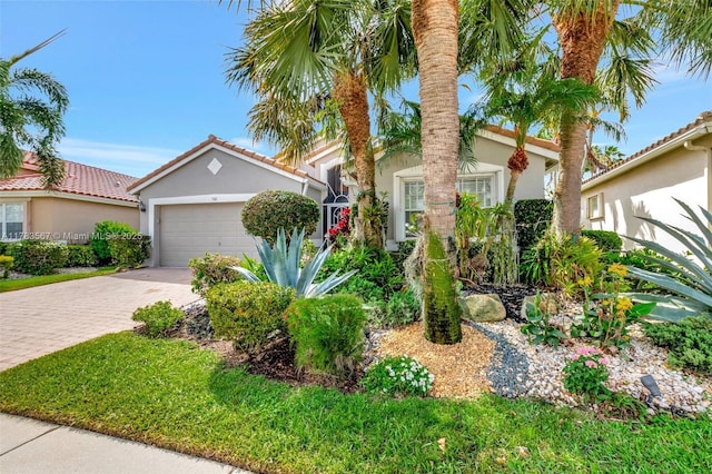 7141 Haviland Cir, Boynton Beach, FL 33437 - mediterranean / spanish house with an attached garage, stucco siding, driveway, and a tiled roof