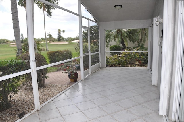 unfurnished sunroom featuring view of golf course