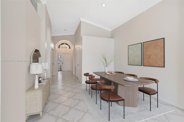 7141 Haviland Cir, Boynton Beach, FL 33437 - dining space featuring an inviting chandelier, baseboards, ornamental molding, and a towering ceiling