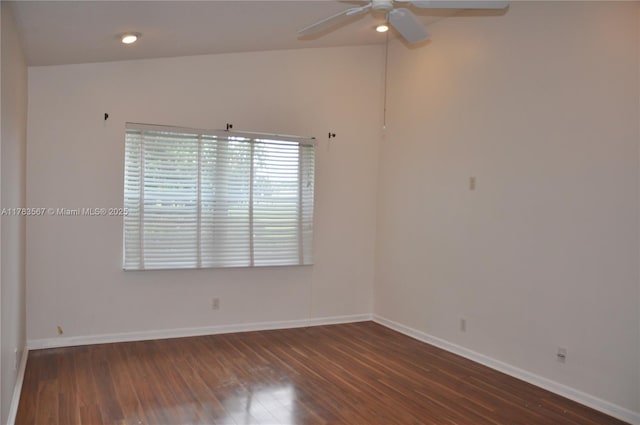 spare room featuring baseboards, ceiling fan, and wood finished floors