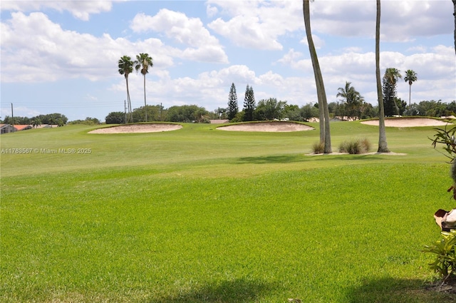 view of property's community featuring a yard and view of golf course