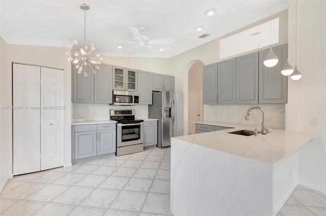 7141 Haviland Cir, Boynton Beach, FL 33437 - kitchen featuring gray cabinetry, appliances with stainless steel finishes, ornamental molding, and a sink