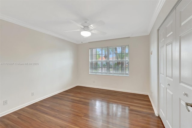 7141 Haviland Cir, Boynton Beach, FL 33437 - unfurnished bedroom featuring a closet, baseboards, crown molding, and wood finished floors