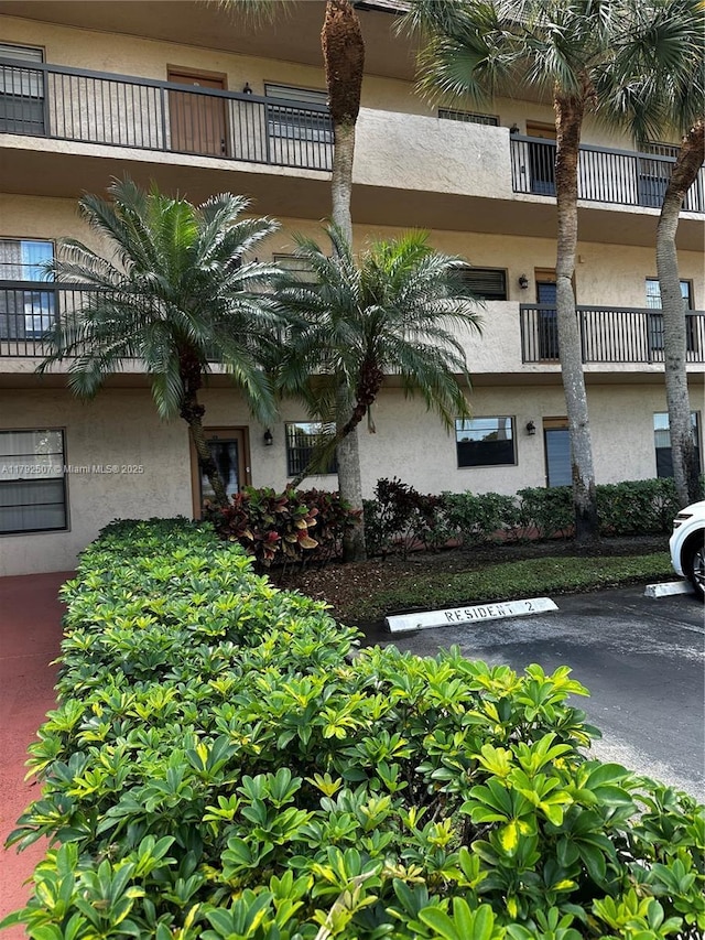 view of building exterior with uncovered parking