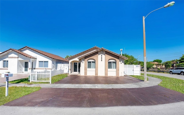 6829 W 26th Ave, Hialeah, FL 33016 - mediterranean / spanish house with fence, driveway, and stucco siding