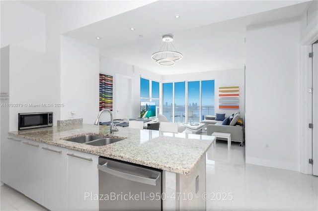 950 Brickell Bay Dr Unit 4710, Miami, FL 33131 - kitchen featuring a sink, appliances with stainless steel finishes, light stone countertops, white cabinetry, and recessed lighting