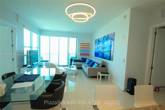 950 Brickell Bay Dr Unit 4710, Miami, FL 33131 - living room featuring baseboards, an inviting chandelier, a healthy amount of sunlight, and visible vents
