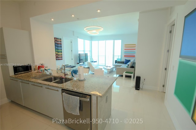 950 Brickell Bay Dr Unit 4710, Miami, FL 33131 - kitchen featuring a peninsula, light stone countertops, baseboards, a sink, and appliances with stainless steel finishes