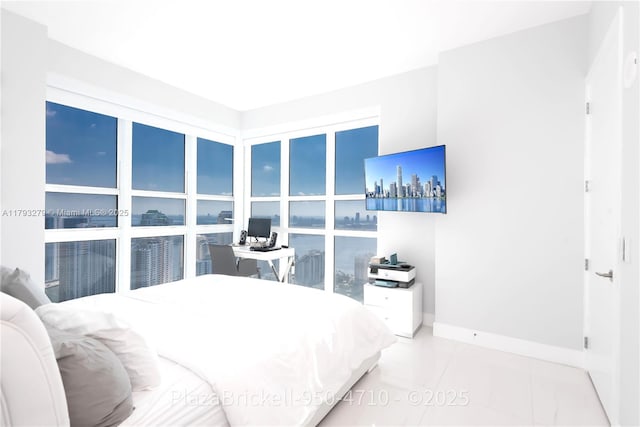 950 Brickell Bay Dr Unit 4710, Miami, FL 33131 - bedroom featuring an office area, baseboards, and tile patterned flooring