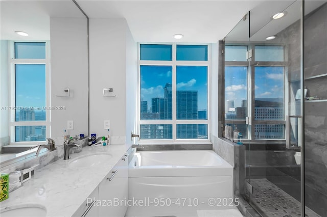 950 Brickell Bay Dr Unit 4710, Miami, FL 33131 - full bath with double vanity, a bath, a stall shower, a city view, and recessed lighting