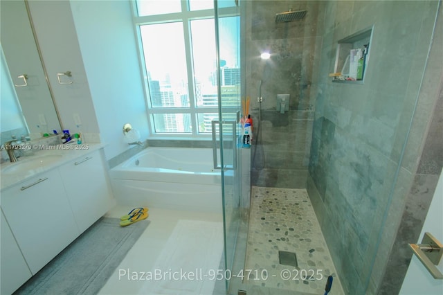950 Brickell Bay Dr Unit 4710, Miami, FL 33131 - full bathroom featuring a garden tub, tile patterned flooring, vanity, a city view, and a stall shower