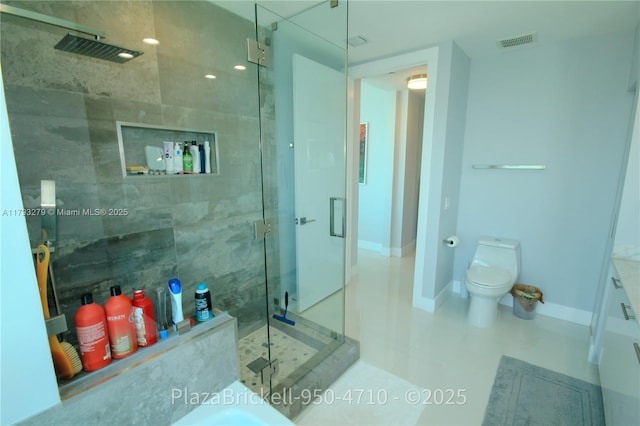 950 Brickell Bay Dr Unit 4710, Miami, FL 33131 - bathroom with visible vents, tile patterned flooring, a shower stall, baseboards, and toilet