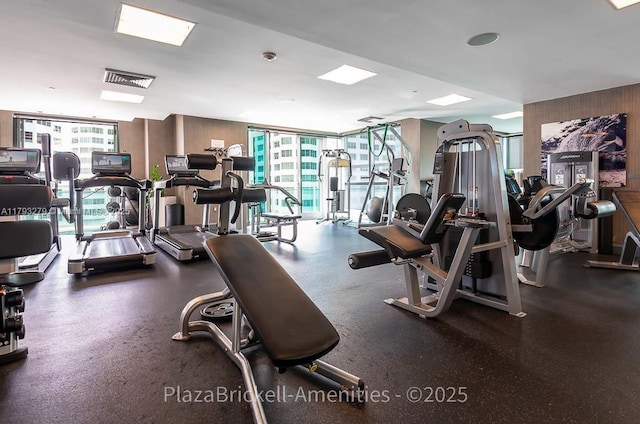 950 Brickell Bay Dr Unit 4710, Miami, FL 33131 - exercise room featuring wooden walls and expansive windows