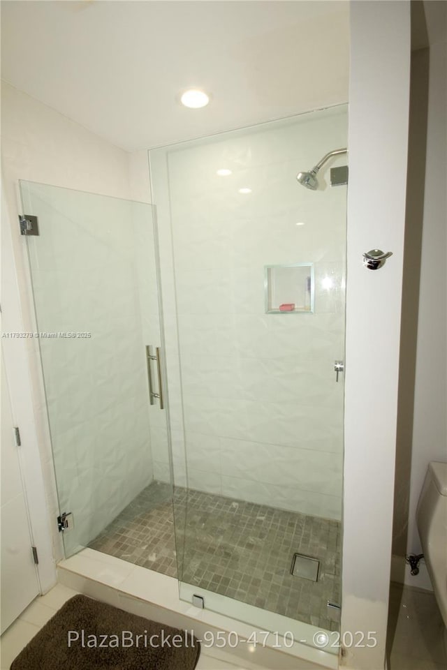 950 Brickell Bay Dr Unit 4710, Miami, FL 33131 - bathroom featuring tile patterned flooring and a stall shower