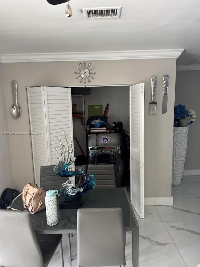 dining space with crown molding, visible vents, marble finish floor, washer / dryer, and baseboards