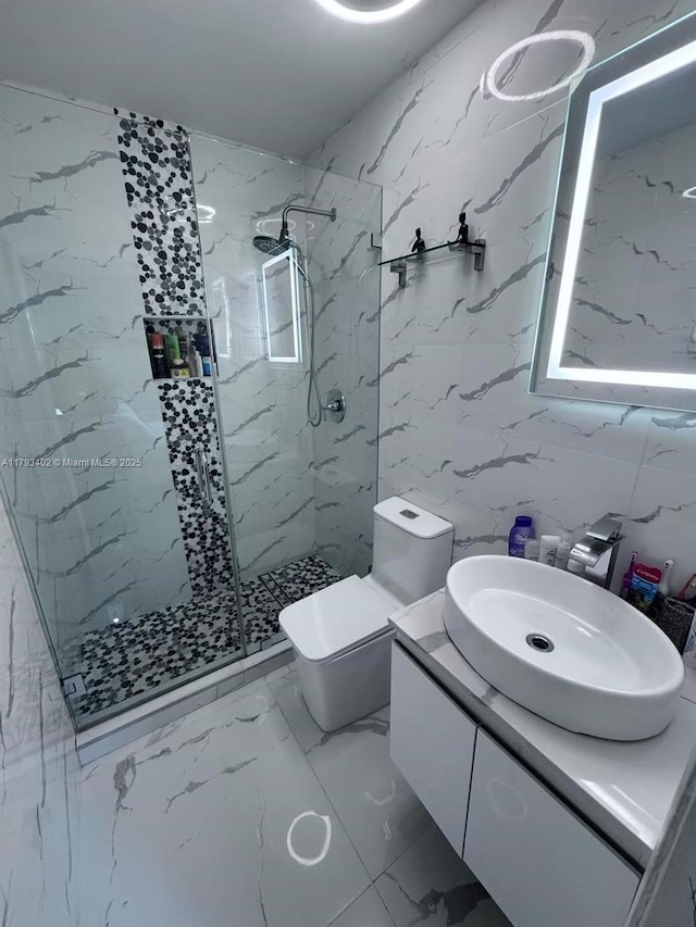 full bath featuring a marble finish shower, vanity, toilet, and marble finish floor