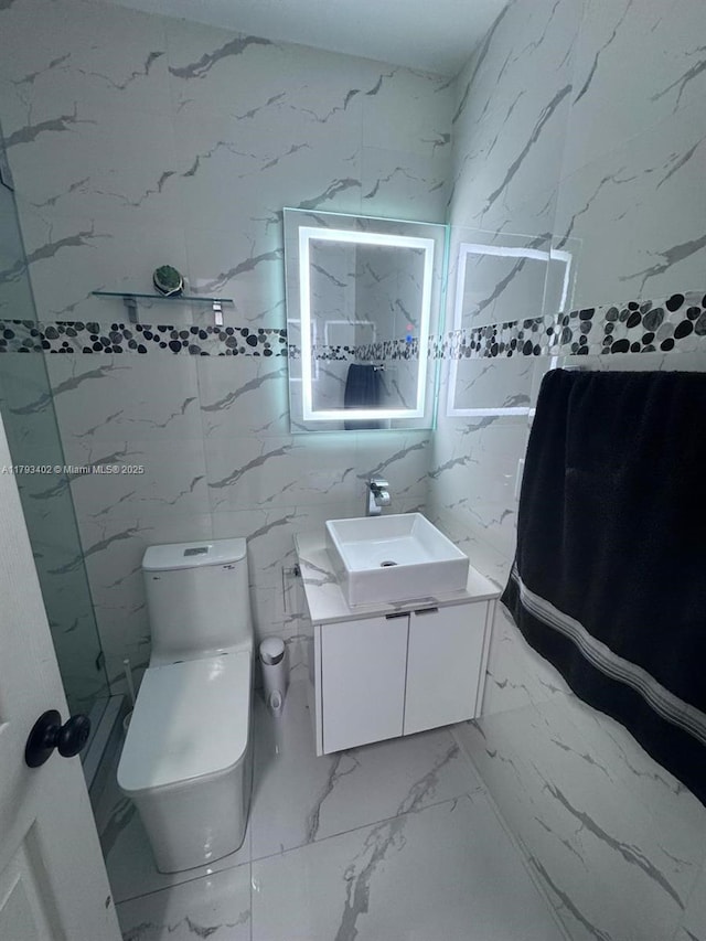 bathroom featuring vanity, toilet, and marble finish floor