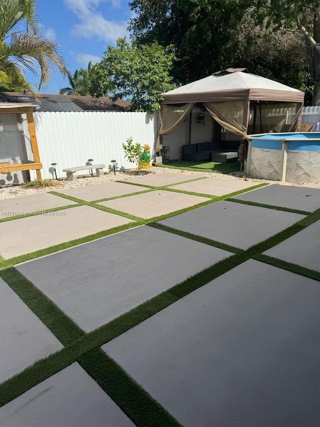 view of yard featuring a patio, fence, a jacuzzi, and a fenced in pool