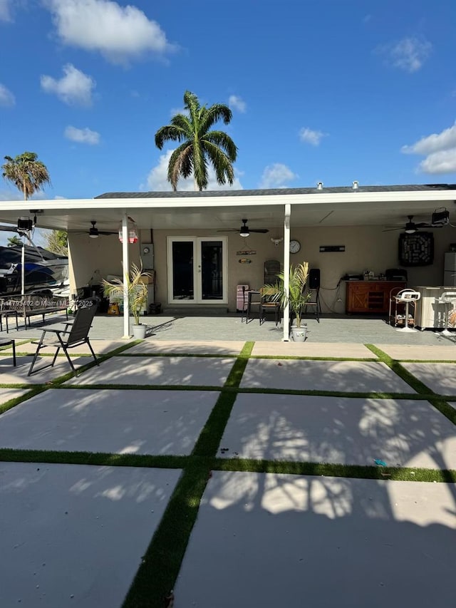 back of property featuring french doors, a ceiling fan, a patio area, and stucco siding