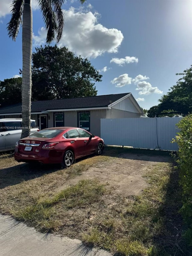 ranch-style house featuring fence