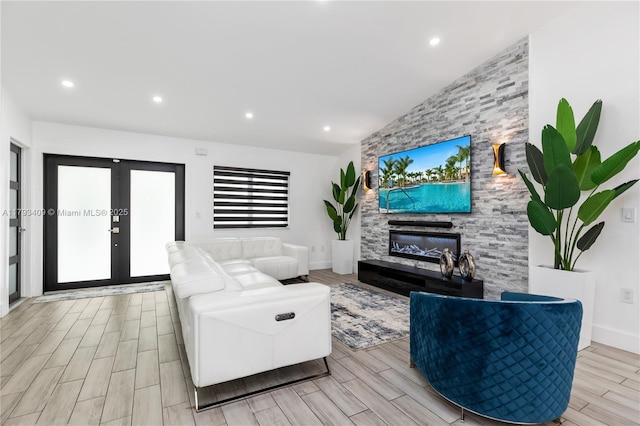 living area featuring recessed lighting, vaulted ceiling, wood finish floors, and a fireplace