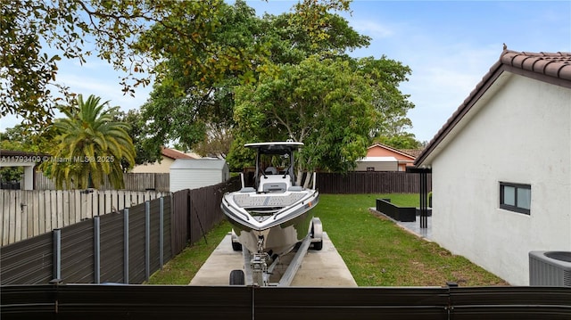 view of yard featuring central AC unit and fence private yard