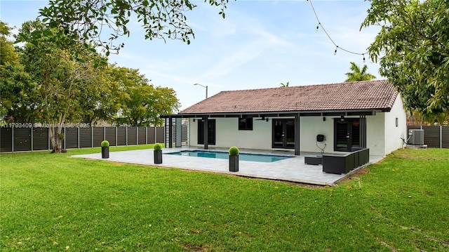 back of property with a patio area, a fenced in pool, cooling unit, a fenced backyard, and stucco siding