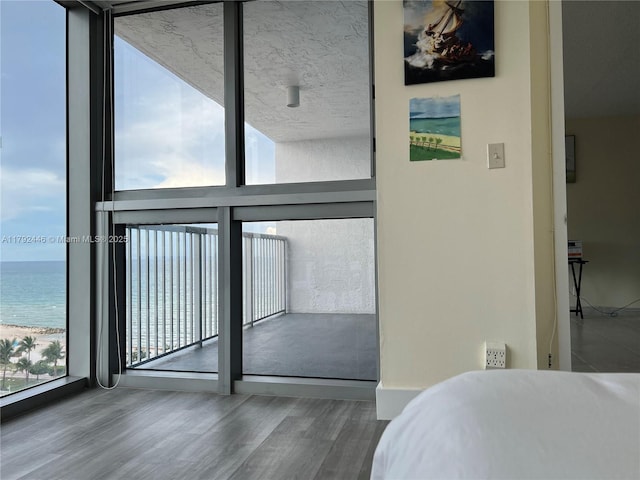 2655 Collins Ave Unit 1405, Miami Beach, FL 33140 - interior space with a water view, a wall of windows, and wood finished floors