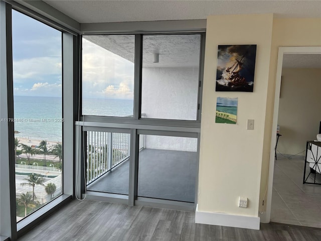 2655 Collins Ave Unit 1405, Miami Beach, FL 33140 - entryway featuring a water view, floor to ceiling windows, and wood finished floors