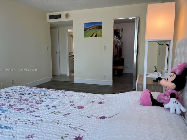 2655 Collins Ave Unit 1405, Miami Beach, FL 33140 - bedroom with visible vents, a closet, wood finished floors, baseboards, and a spacious closet