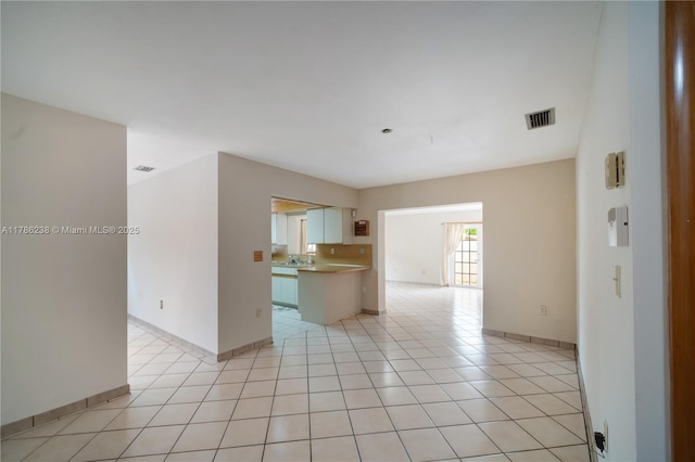 interior space featuring visible vents, baseboards, and light tile patterned floors