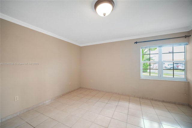 spare room with baseboards and ornamental molding
