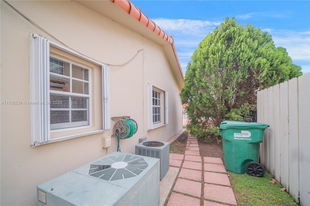 view of patio / terrace featuring fence and central AC