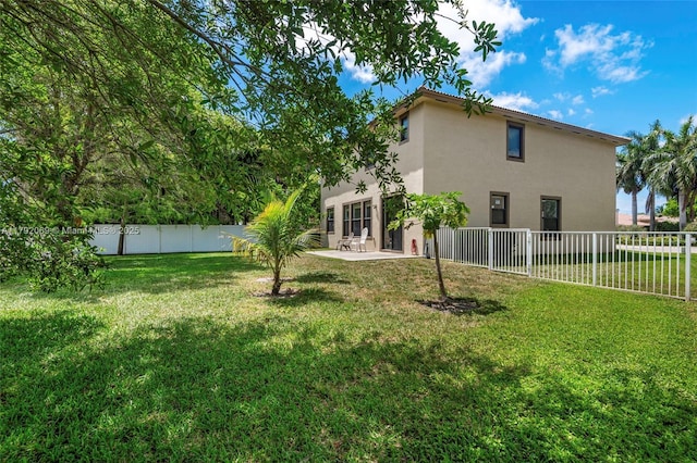 view of yard with a patio and a fenced backyard